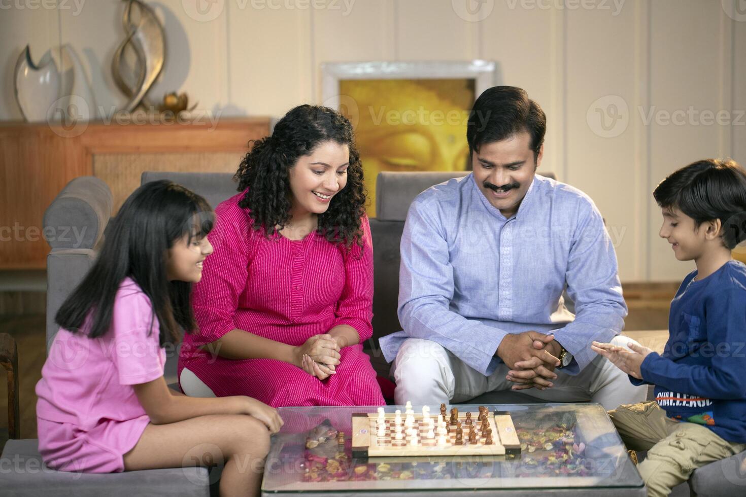 Cute Family Playing Chess Together At Home In The Living Room photo