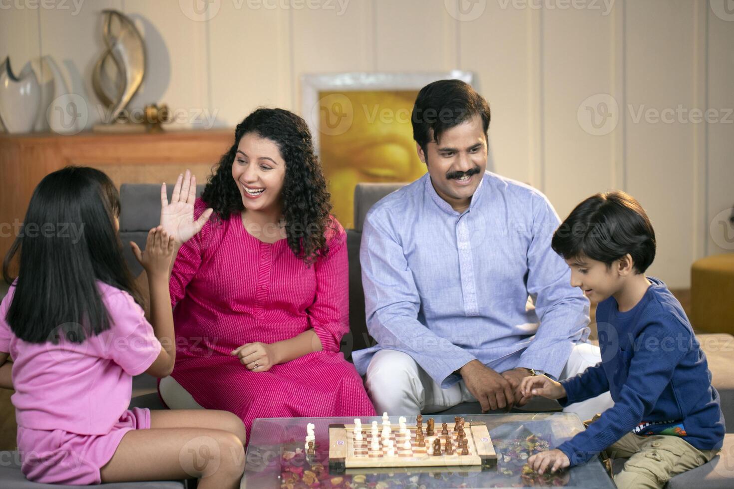 Amazing Family Playing Chess Together At Home photo