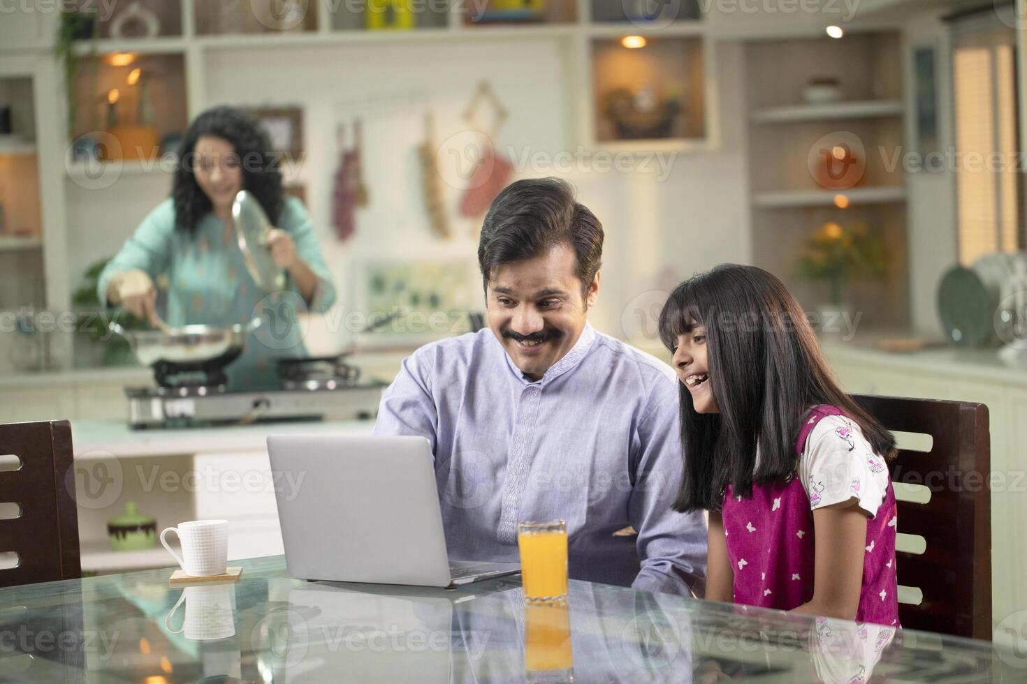 Daddy And Daughter While Watching On Laptop photo