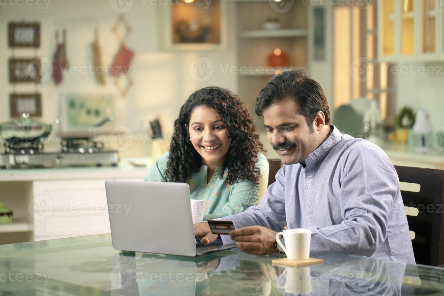 Couple Shopping Online On Laptop And Paying With Credit Card photo
