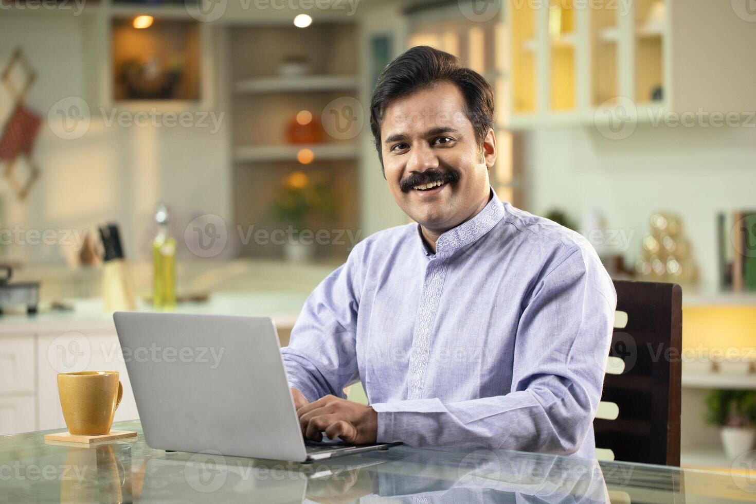 Smiling Man Posing In Front Of Camera photo