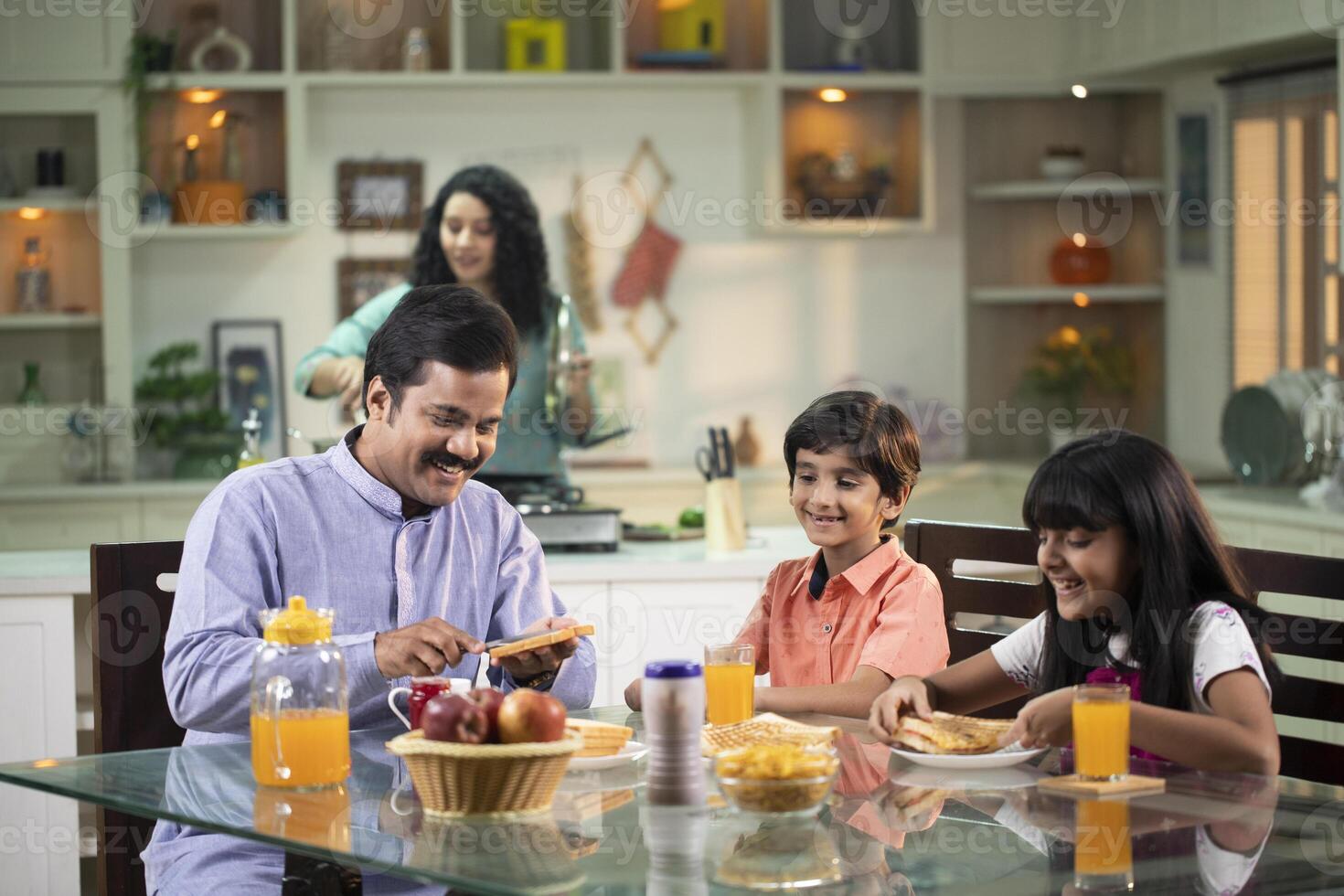 Asian Father Spreading Jam On Bread photo