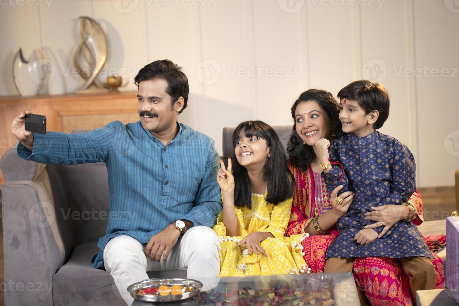 Father Mother Son And Daughter Smiling While Taking Selfie photo