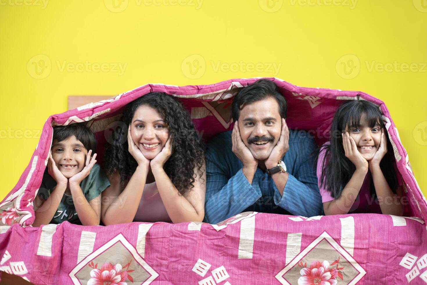 Happy Family Lying Under A Bedsheet photo