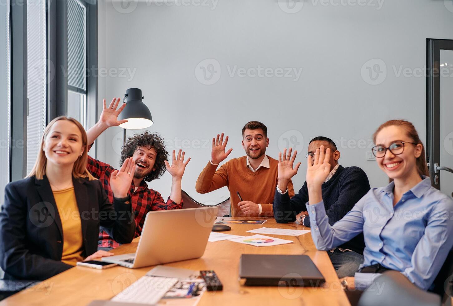 Successful and Happy Business Colleagues Waving Hands in Meeting. photo