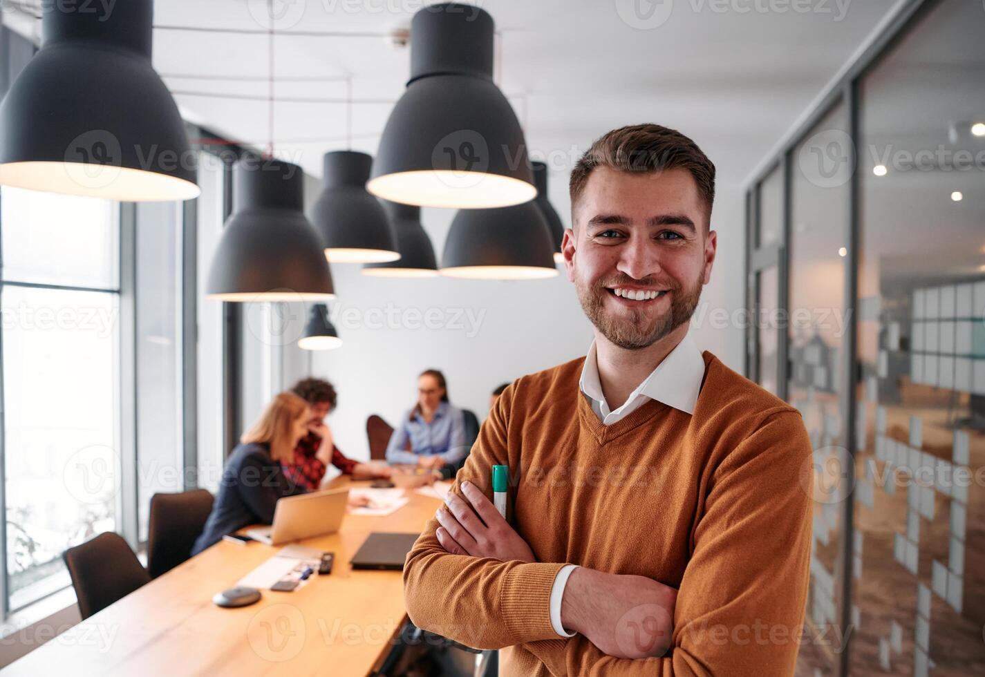 Confident Businessman Leading Collaborative Meeting in Modern Office Setting. photo