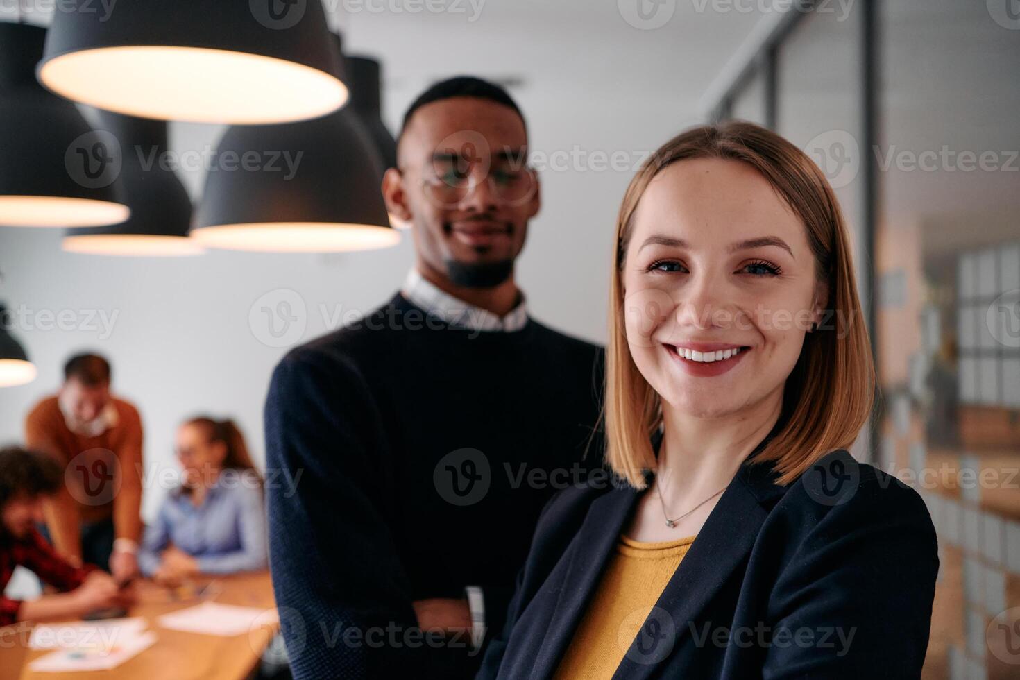 Dynamic Leadership Duo. Blonde Director and Young African American Entrepreneur in Office Setting. photo