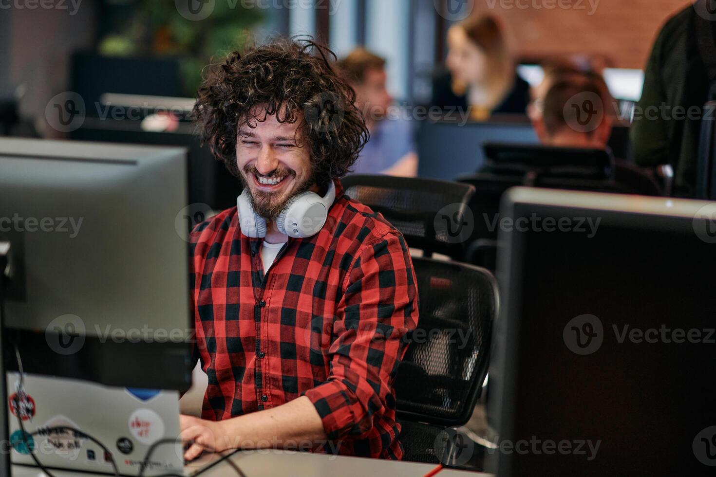 Focused Programmer With Afro Hairstyle in Plaid Shirt Working on Computer in Office Environment photo