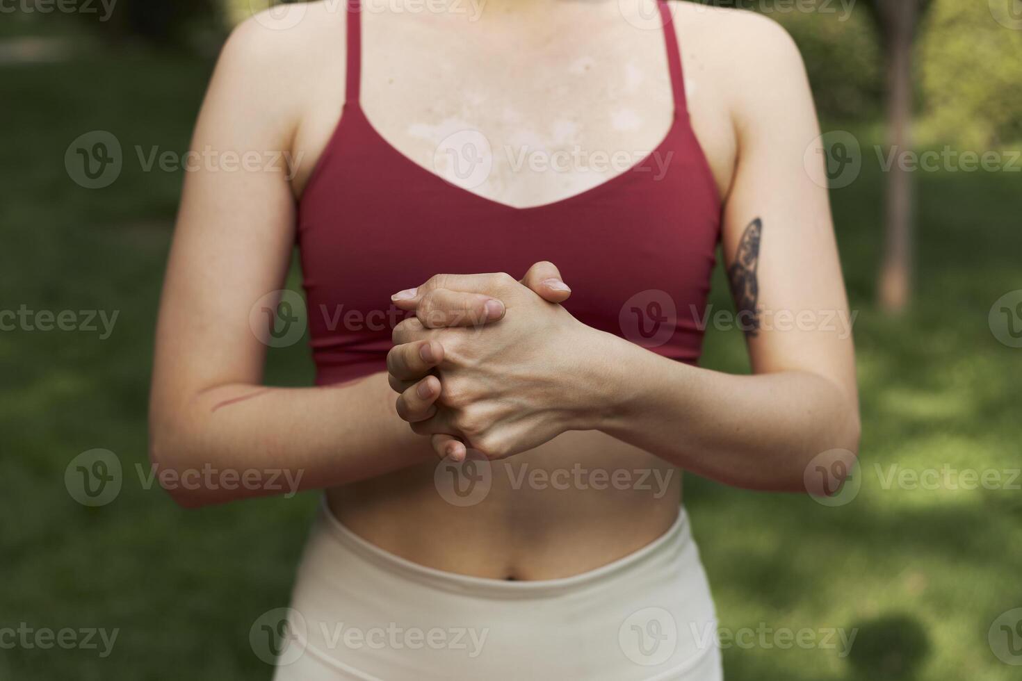 Young adult female stretching muscle in the park outdoor photo