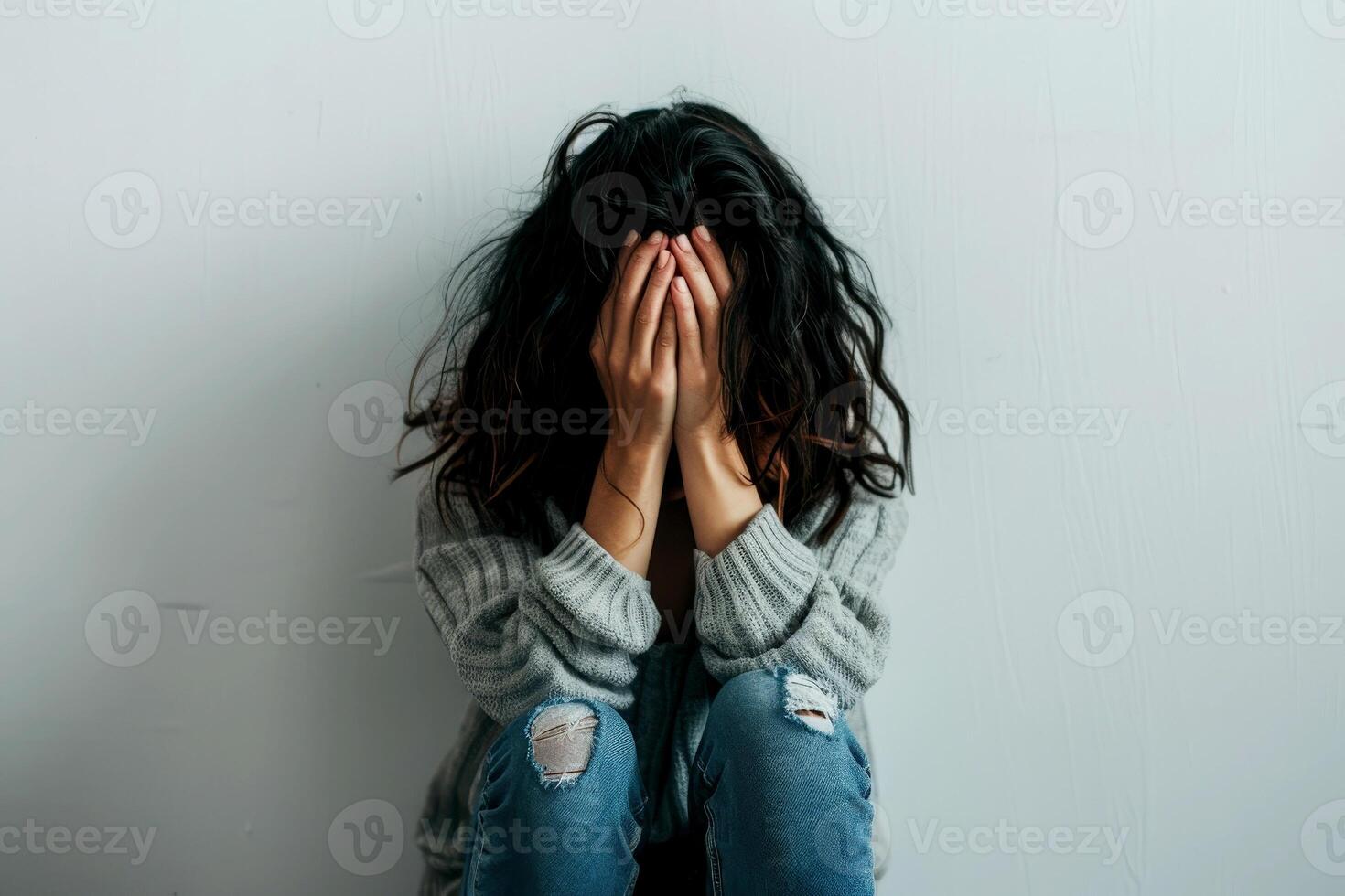 a state of distress man with hands covering her face in fear and horror concept. A close-up portrait of a person covering their face with their hands, conveying a sense of shame or discomfort. photo