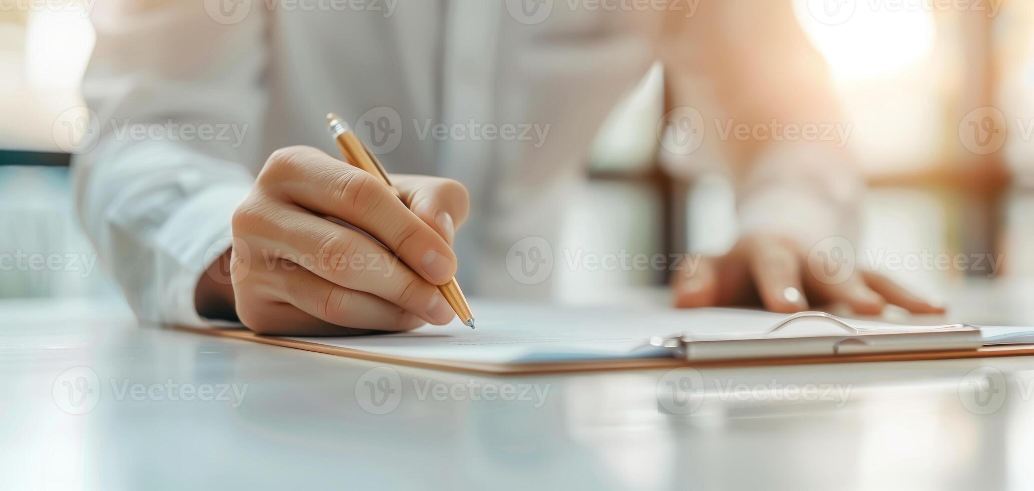Close-up of a person writing on a clipboard with a pencil, capturing a professional and focused moment. Ideal for business or education uses. photo