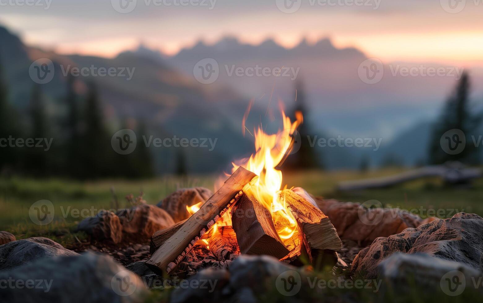 A cozy campfire burning at dusk in a scenic mountain landscape, surrounded by nature and tranquility, perfect for outdoor enthusiasts. photo