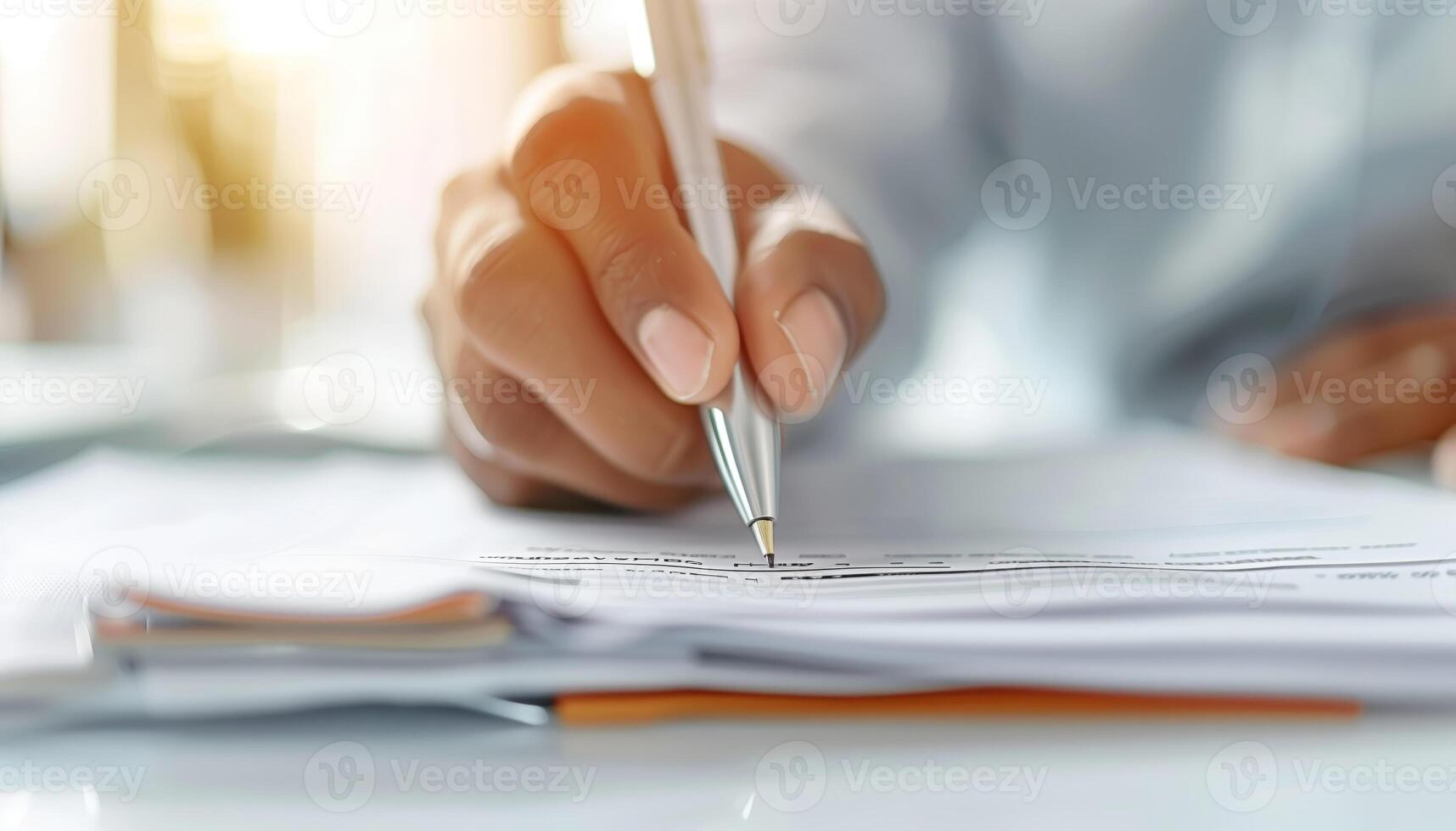 Close-up of a person's hand writing with a pen on paper, focusing on business, contract, or documentation in a professional setting. photo