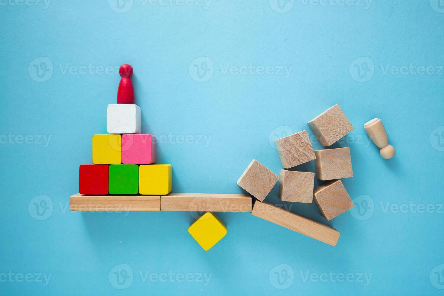 Manager balancing seesaw with team on one side and failure on the other photo