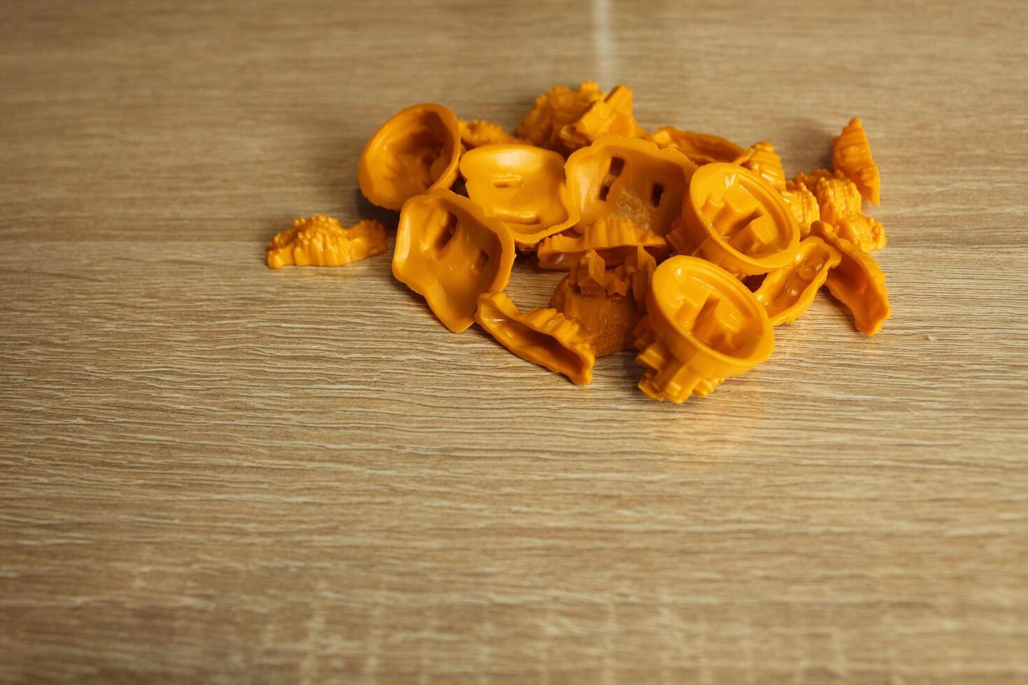 yellow game elements of the mipla of the board game catan on a light beige background photo