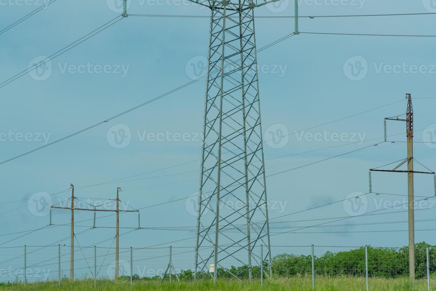 High voltage towers with sky background. Power line support with wires for electricity transmission. High voltage grid tower with wire cable at distribution station. Energy industry, energy saving photo