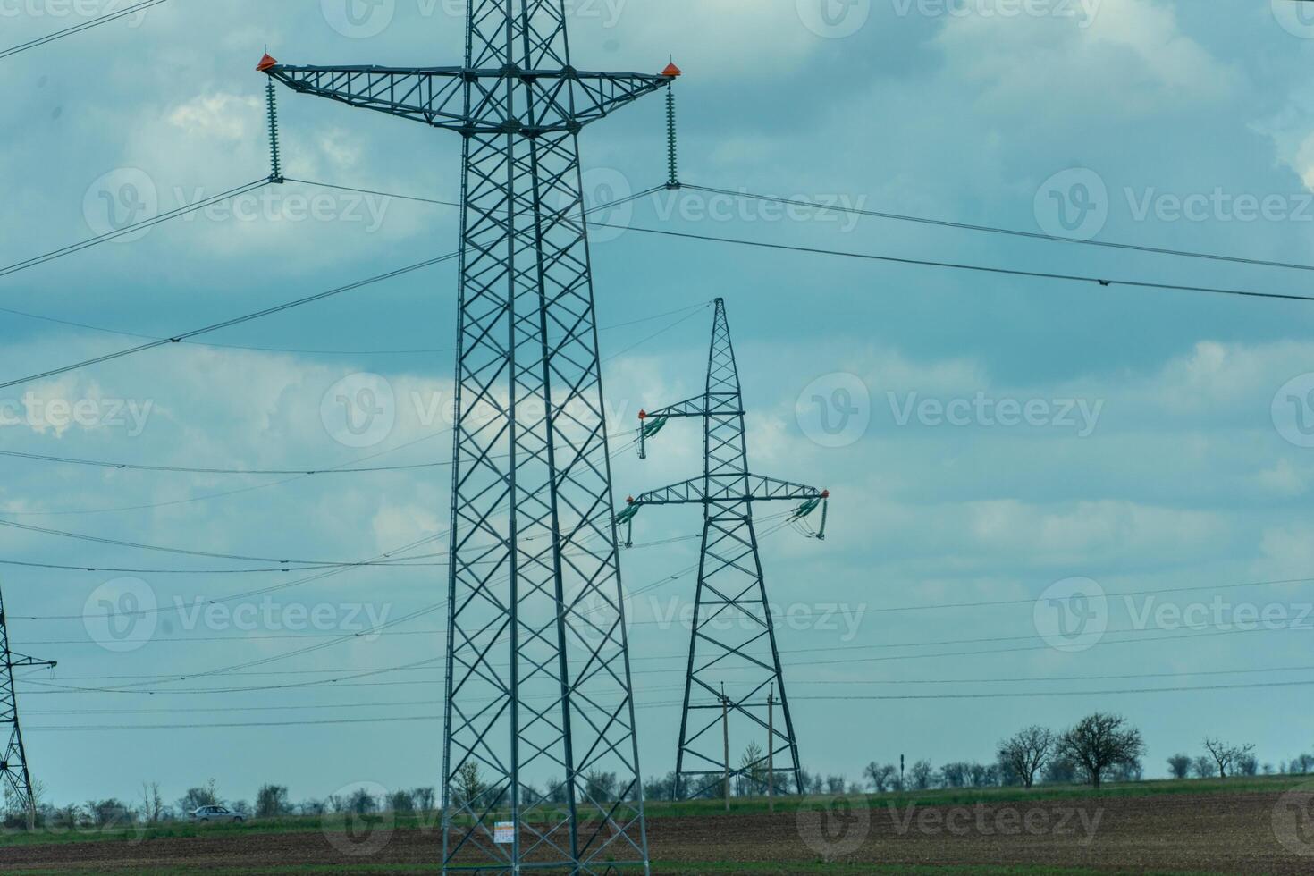 High voltage towers with sky background. Power line support with wires for electricity transmission. High voltage grid tower with wire cable at distribution station. Energy industry, energy saving photo