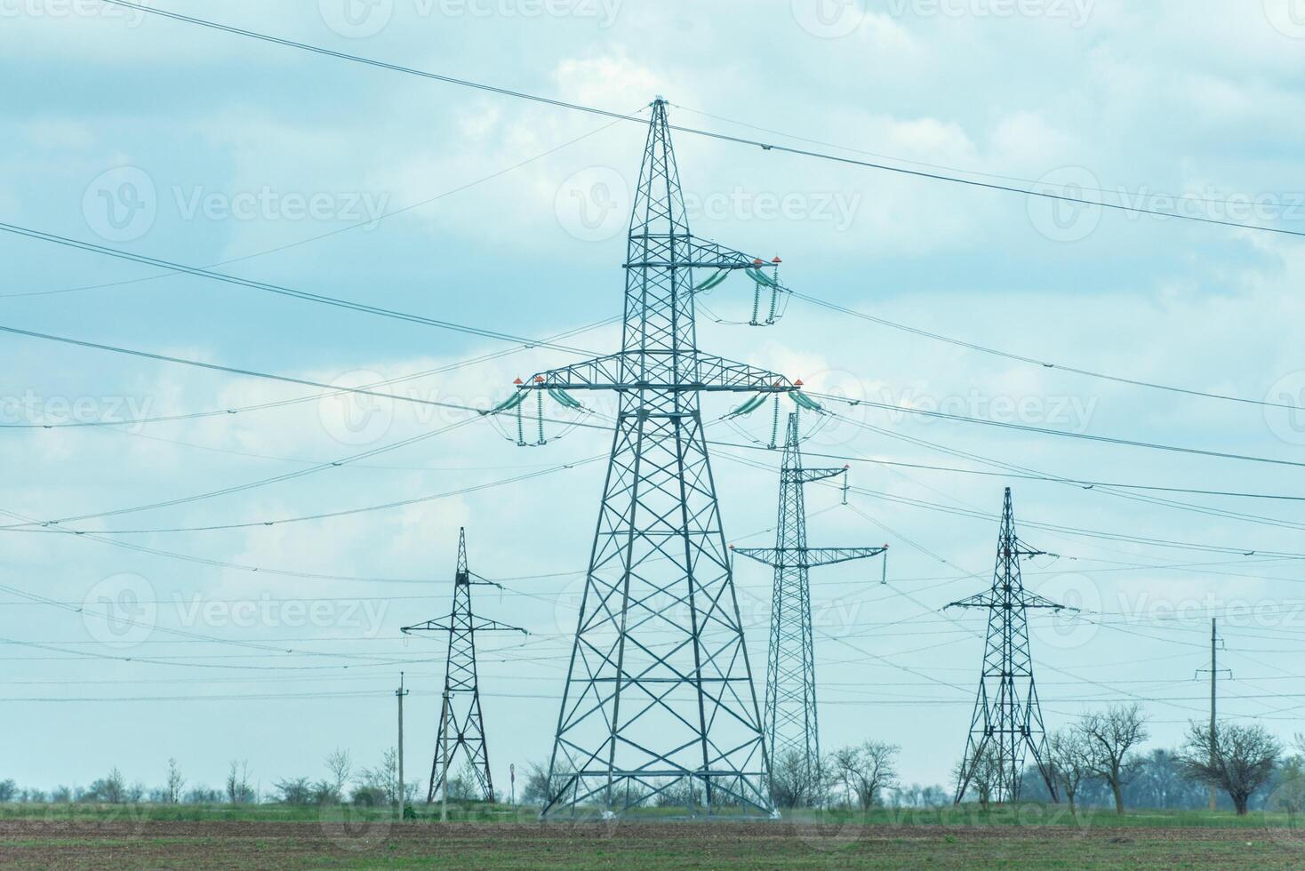 High voltage towers with sky background. Power line support with wires for electricity transmission. High voltage grid tower with wire cable at distribution station. Energy industry, energy saving photo
