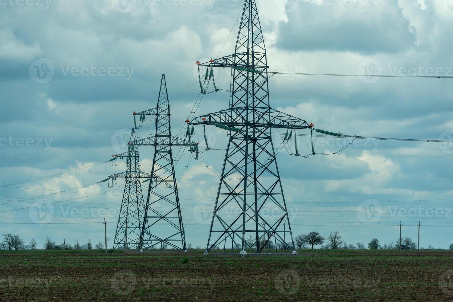 High voltage towers with sky background. Power line support with wires for electricity transmission. High voltage grid tower with wire cable at distribution station. Energy industry, energy saving photo