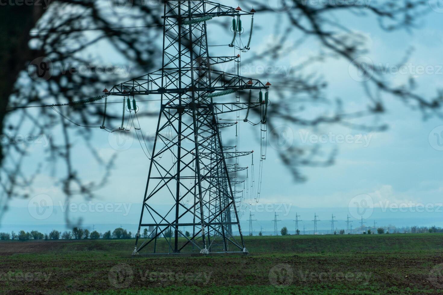 High voltage towers with sky background. Power line support with wires for electricity transmission. High voltage grid tower with wire cable at distribution station. Energy industry, energy saving photo