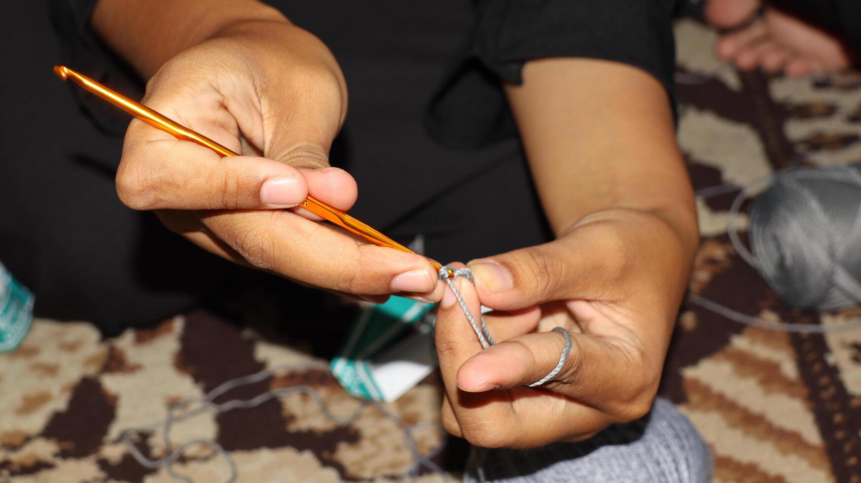 Female hands close-up. Handmade. Colored yarn and knitting needles. photo