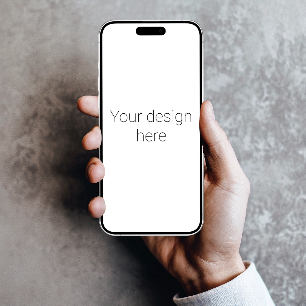 Mockup of white smartphone similar to iphone in person's hand. Gray wall on background psd