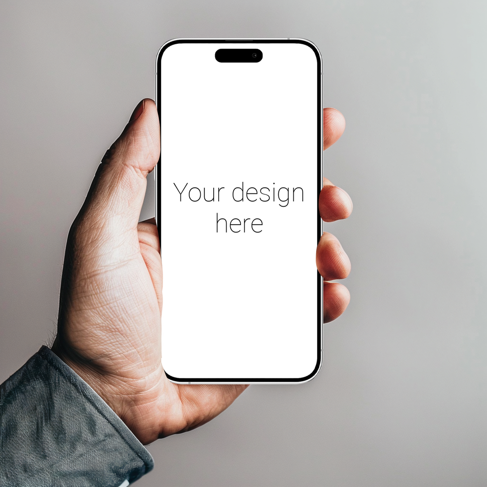 Mockup of white smartphone similar to iphone in person's hand. Gray wall on background psd
