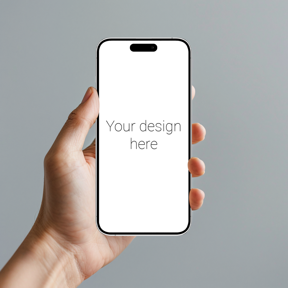Mockup of white smartphone similar to iphone in person's hand. Gray wall on background psd