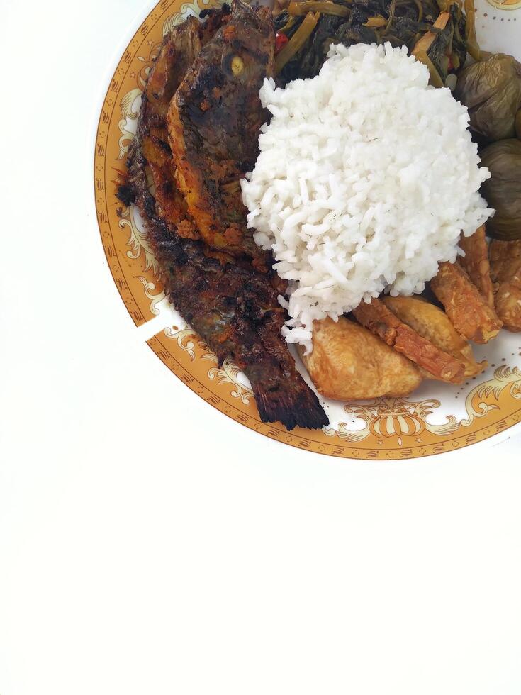 A closeup view of grilled white fish, in a restaurant or kitchen setting. photo
