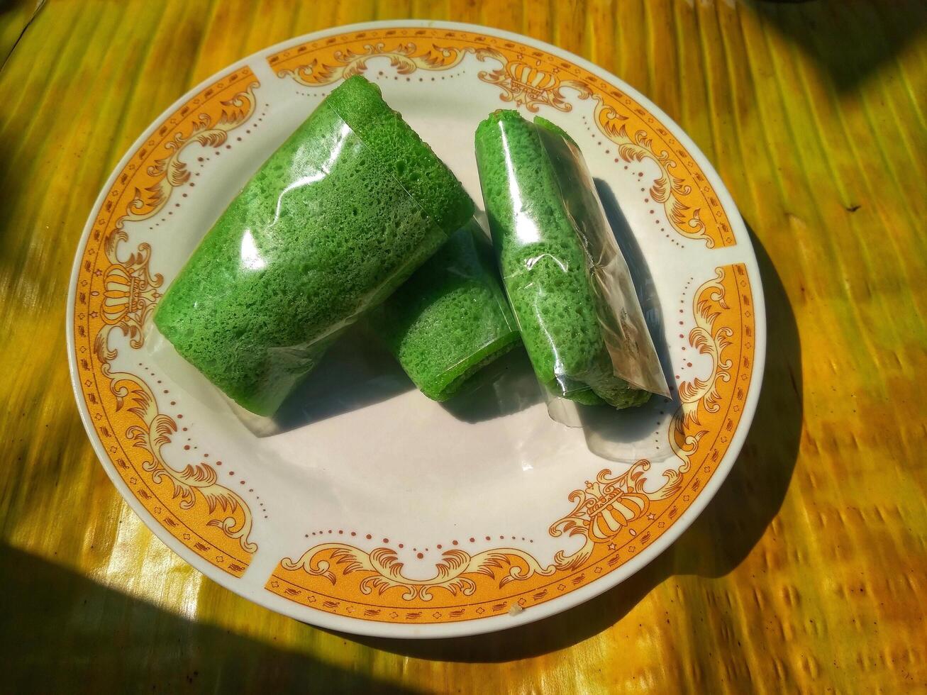 Kue Dadar Gulung is traditional cake that popular in Indonesia, Malaysia, Singapore. It made from flour, coconut, palm sugar and pandanus flavors. photo