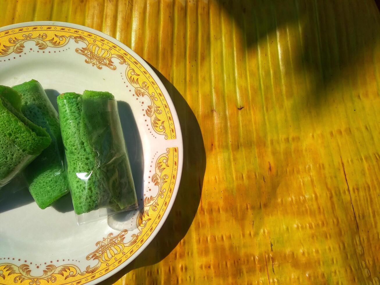 Kue Dadar Gulung is traditional cake that popular in Indonesia, Malaysia, Singapore. It made from flour, coconut, palm sugar and pandanus flavors. photo
