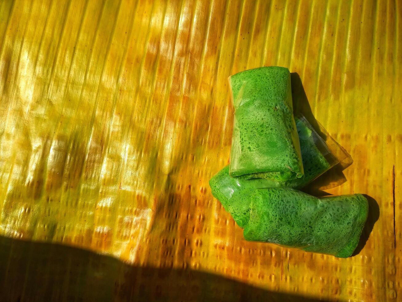 Kue Dadar Gulung is traditional cake that popular in Indonesia, Malaysia, Singapore. It made from flour, coconut, palm sugar and pandanus flavors. photo