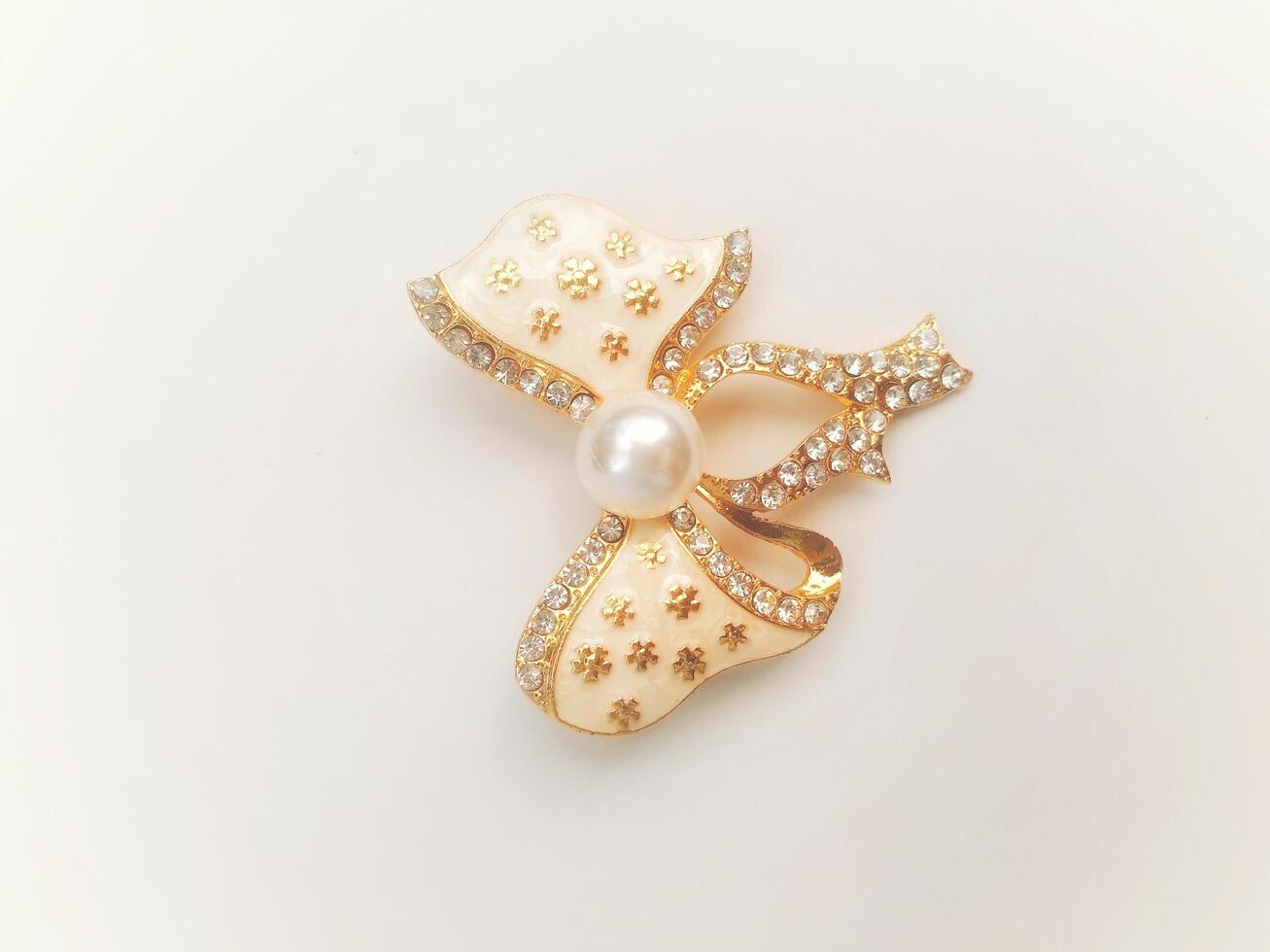 Accessories shaped like butterflies and melodies in yellow and white with imitation gems are suitable for use at events and add to the elegance of women. on white background photo