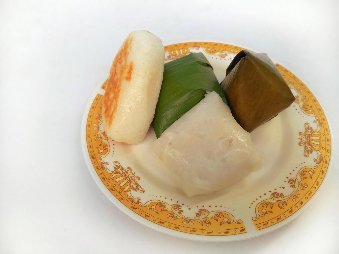 Various traditional Indonesian cakes in the market.Traditional market snacks from Indonesia are nagasari, mendut wrapped in banana leaves photo