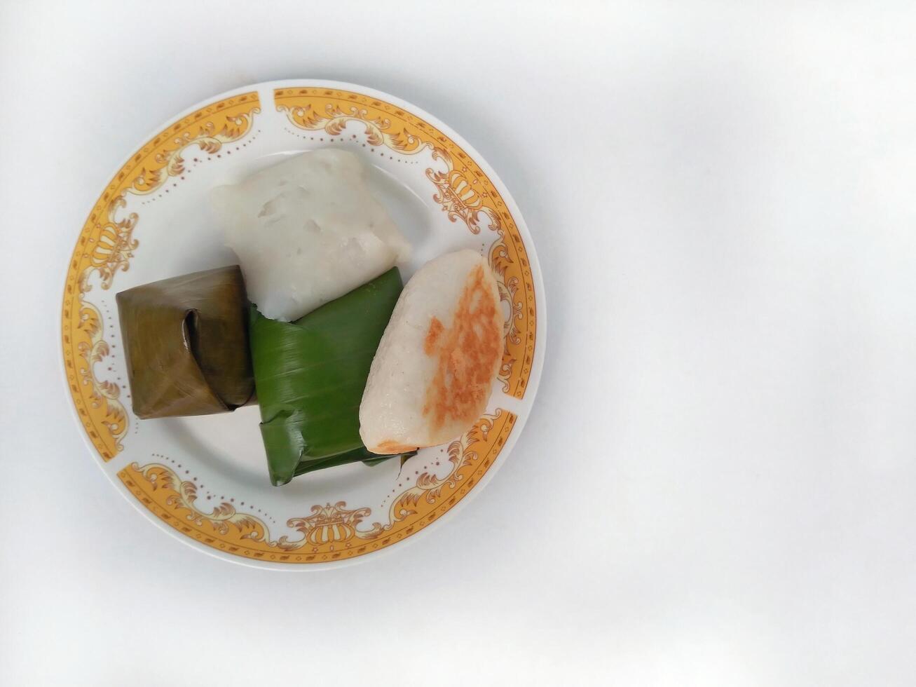 Various traditional Indonesian cakes in the market.Traditional market snacks from Indonesia are nagasari, mendut wrapped in banana leaves photo
