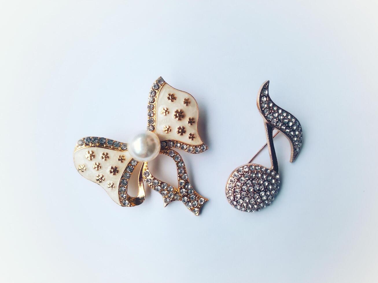 Accessories shaped like butterflies and melodies in yellow and white with imitation gems are suitable for use at events and add to the elegance of women. on white background photo