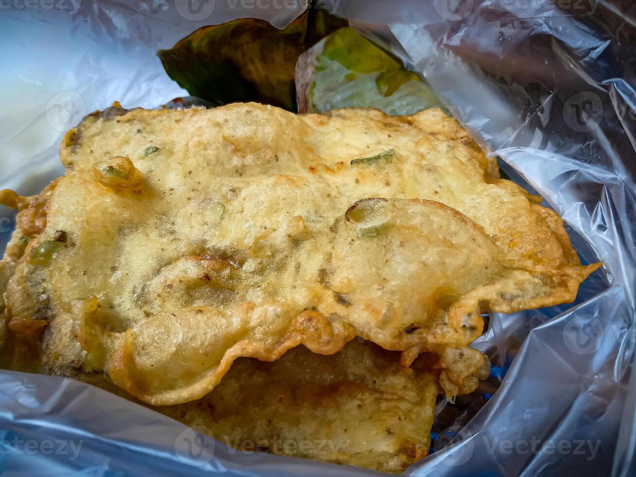 Tempe Mendoan is a traditional food made from tempeh covered in flour batter with a mixture of sliced leeks and spices. cooked by frying. Selective fokus. photo