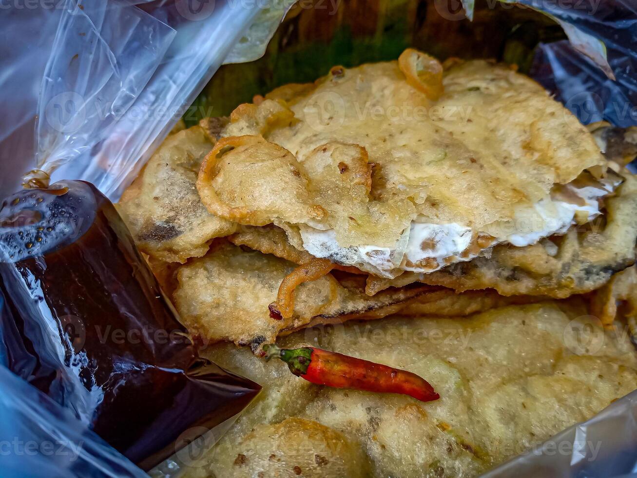 Tempe Mendoan is a traditional food made from tempeh covered in flour batter with a mixture of sliced leeks and spices. cooked by frying. Selective fokus. photo