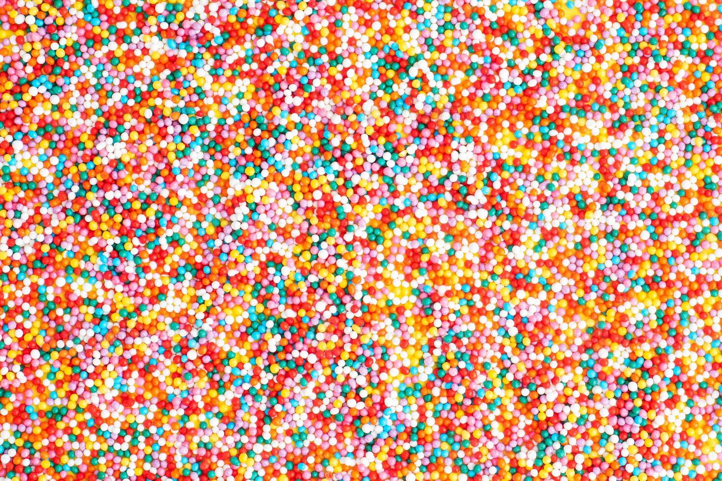Confectionery sprinkles colored glazed sugar, close up. Background. photo