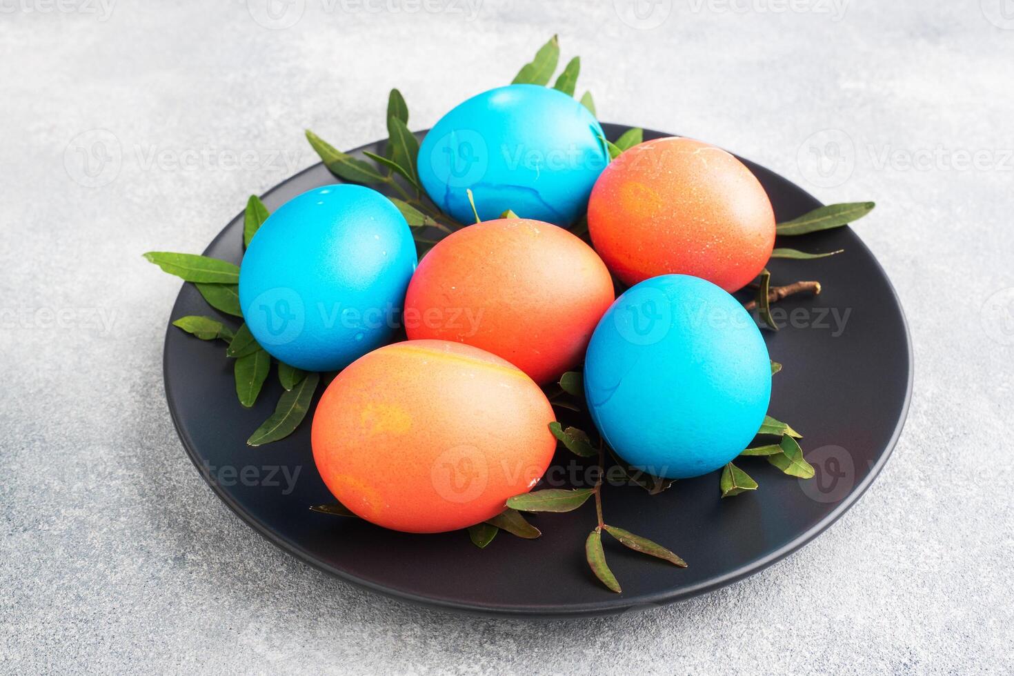 Easter eggs painted by hand colored on a concrete table, top view. photo