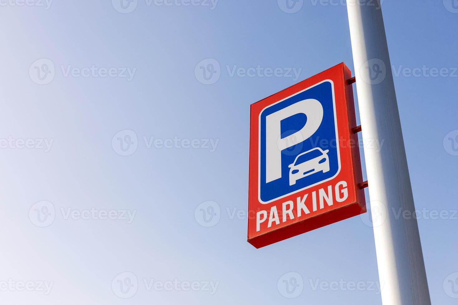 Red and blue parking sign against clear sky, copy space for text. Perfect for use in content related to urban planning, transportation, city infrastructure, public parking facilities. Carpark price. photo