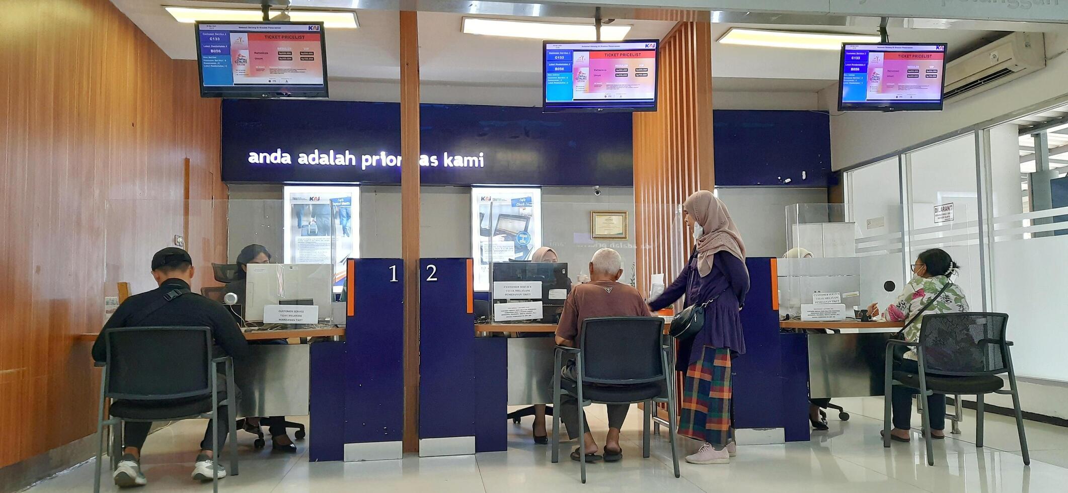 View of the Pasar Senen train station area. Local train and passengers activity. Jakarta, Indonesia - June 8, 2024 photo
