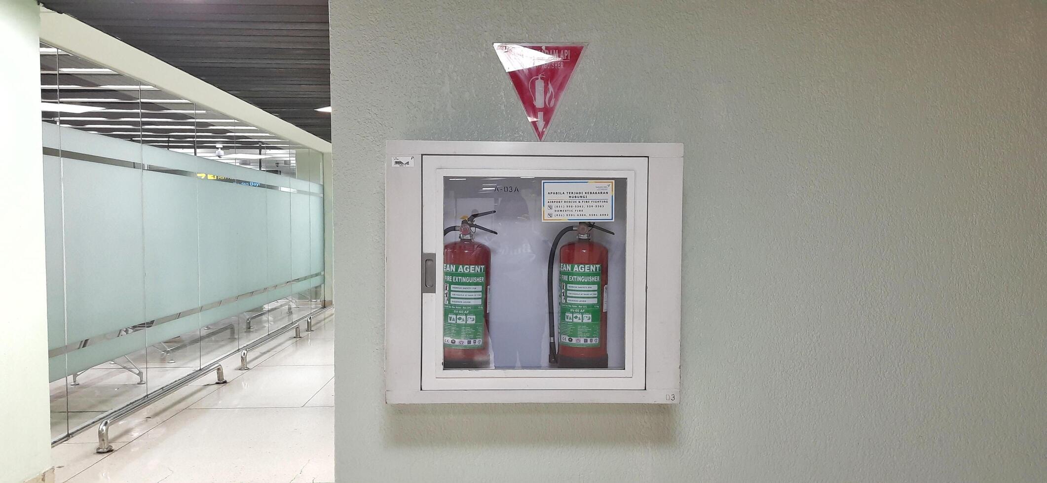 Two hydrants in a box attached to the wall in the terminal 1A Jakarta Indonesia June 11 2024 photo