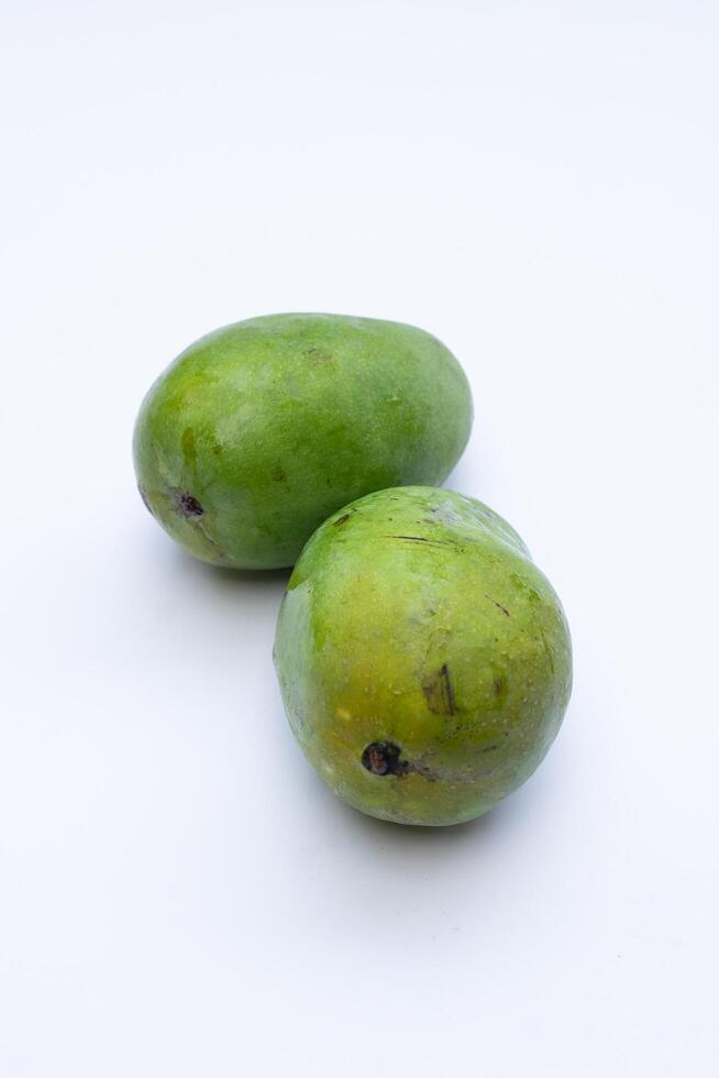 Fresh mango fruit on a white background, highlighting its vibrant yellow color and smooth texture, perfect for food photography and advertising photo