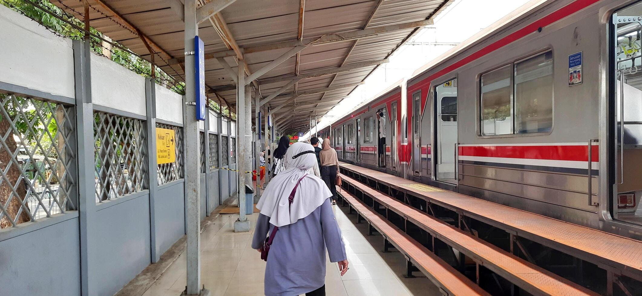 View of the Pasar Senen train station area. Local train and passengers activity. Jakarta, Indonesia - June 8, 2024 photo