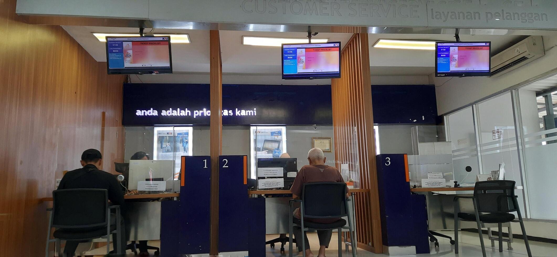 Customer service queue activity for registration of reduced Indonesian train ticket rates for the elderly in the Pasar Senen train station area. Jakarta, Indonesia - June 8, 2024 photo