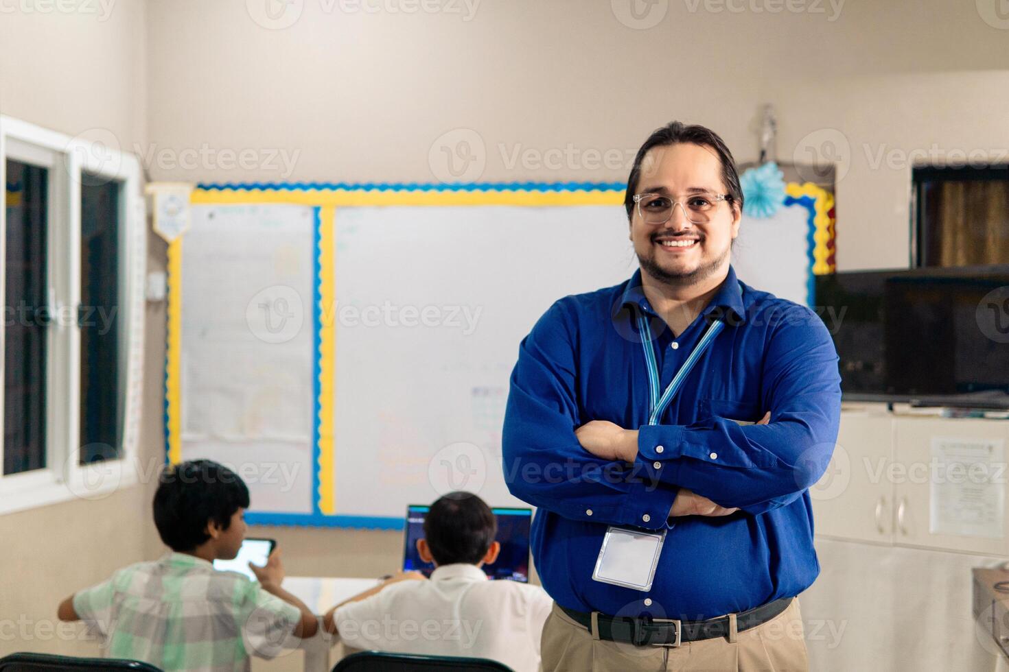 Portrait of latin american adult teacher in classroom looking at camera. photo