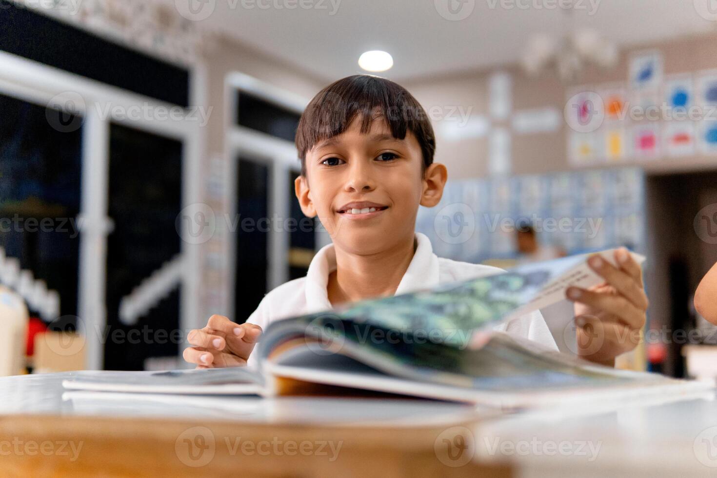 Portrait of latin american elementary child in a classroom. photo