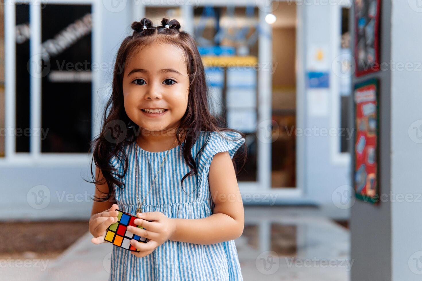 Portrait of little girl student smiling looking at camera. preschool concept. photo