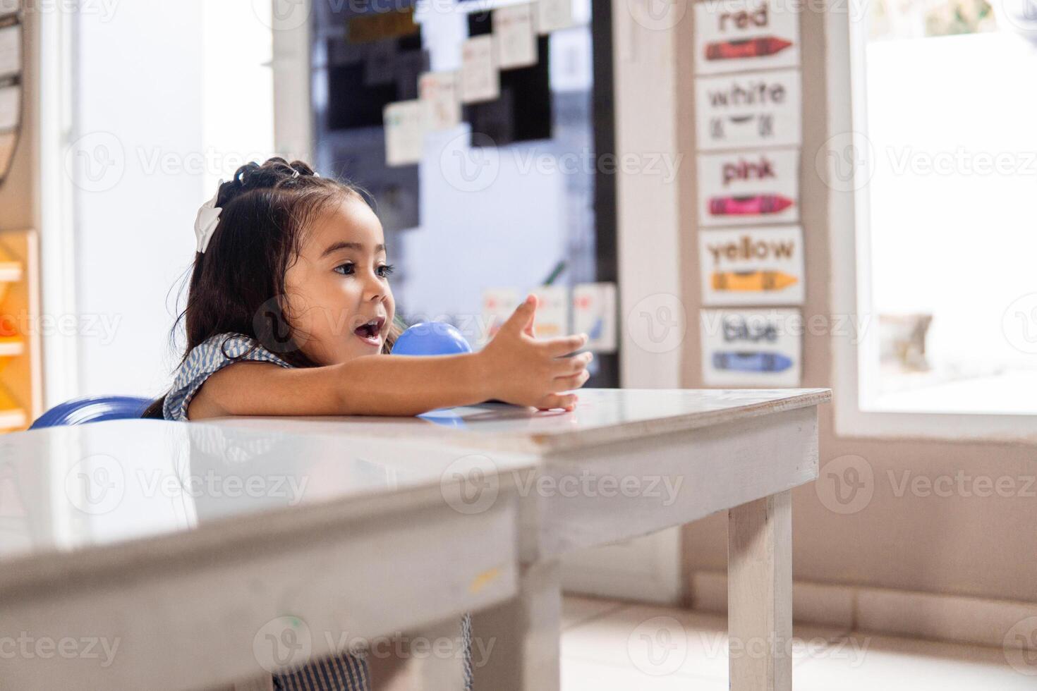 Portrait of little girl student learning in a class. photo